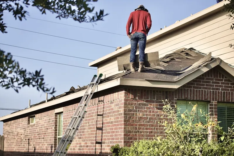 Professional roofer working on a residential roof in Martintown